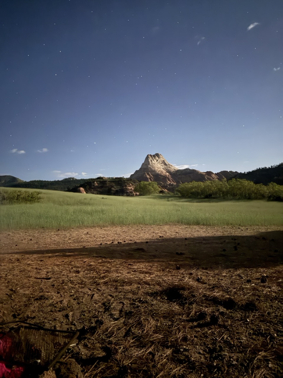 A procession along a red-rock ridge at dusk
